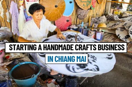 An artisan in Chiang Mai hand-painting a traditional umbrella surrounded by colorful handmade crafts, highlighting the cultural richness of Northern Thailand.
